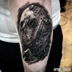 a tattoo on the arm of a man with a hockey mask