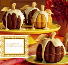 there are three pumpkin cakes on the plates and one is decorated with icing,