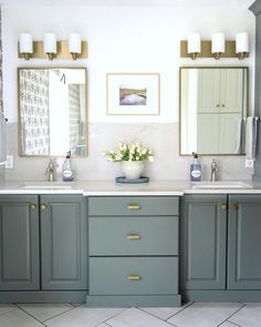 a bathroom with double sinks and two mirrors on the wall next to eachother