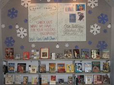 a display case with books on it and snowflakes