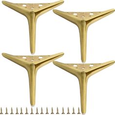 four gold metal brackets with screws on them