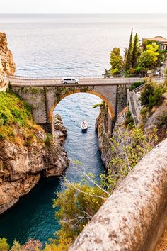 a bridge over a river with a boat going under it