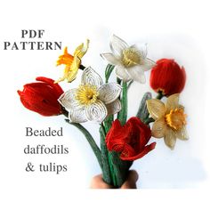 a hand holding a bunch of flowers on top of a white background with the words beaded daffodils and tulips