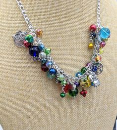 "Old Fashioned Christmas Charm Necklace Search my shop for \"Christmas\" to find matching bracelet and earrings. Chain is 18\" long with a 3\" extension chain.  It has a lobster claw closure. The stainless steel chain links are filled with a rainbow of glass and gem stone beads and crystals - really pretty. Mixed between the beads and gemstones are vintage Christmas themed charms and tiny jingle bells. This makes a great gift or the perfect holiday accessory for yourself! Your necklace will be c Adjustable Multicolor Nickel-free Charm Necklaces, Adjustable Multicolor Charm Necklaces Nickel Free, Whimsical Multicolor Jewelry With Dangling Charms, Whimsical Multicolor Jewelry With Charms, Whimsical Multicolor Charms Jewelry, Multicolor Dangle Jewelry With Lobster Clasp, Whimsical Dangle Jewelry With Lobster Clasp, Multicolor Nickel-free Costume Jewelry, Multicolor Metal Jewelry As A Gift