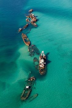 an aerial view of several ships in the water, with caption that reads sand bar off the bermuda triangle that caught 16 ships