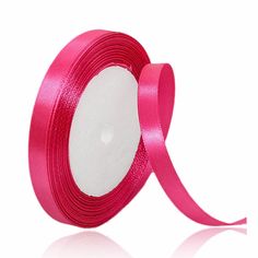 a roll of pink satin ribbon with white center on a white back ground, in front of a white background