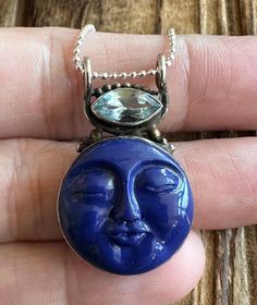 "Lapis Lazuli and Blue Topaz Sterling Silver Pendant 1-5/16\" L by 13/16\" W Carved Lapis gem is 19x19mm. Blue Topaz is 11x5mm. 4.4g Sterling Silver, stamped 925. *Hand carved Lapis gem has a detailed face design and is accented by a marquise Blue Topaz. Pendant is oxidized and has a vintage vibe. 18\" Ball Chain is optional and is 1mm wide, Sterling Silver and 2g. *Please check out my Etsy store for more one of a kind, handmade pieces that feature genuine gemstones and Sterling Silver. I love t Spiritual Blue Topaz Jewelry In Blue, Blue Gemstone Celestial Necklace, Unique Blue Gemstones In Sterling Silver, Faceted Blue Round Gemstones, Spiritual Blue Jewelry With Gemstone Accents, Blue Celestial Birthstone Jewelry, Unique Blue Natural Gemstones, Blue Round Natural Gemstones, Natural Blue Round Gemstones