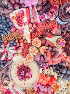 a table topped with lots of different types of food and desserts on top of each other