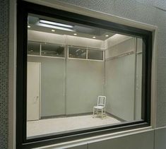 a white chair sitting in front of a mirror on top of a bathroom wall next to a sink