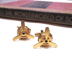 These cufflinks are made with moveable raw brass air plane propellers.  The base measures 1/2" in diameter by 1/8" tall and the blades are 3/4" in diameter (5mm x 10mm x 21mm). They are soldered to gold plated cuff links. Please note that these are raw brass and will develop a patina over time.  If you wish them to go back to their shiny gold appearance, simply buff with a polishing cloth. If you'd like more for a wedding party or another special occasion please contact me! Wright Brothers, Air Plane, Kitty Hawk, Tie Tack, Tie Accessories, Suit And Tie, Cuff Links, Raw Brass, Soldering