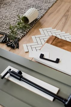 a close up of a door handle on a wooden floor next to rugs and other items