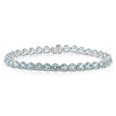 Milgrain detailed half bezel settings provide extra sparkle to an already stunning aquamarine tennis bracelet. Ends with a catch clasp with a button and security latch. Half Bezel Setting, Half Bezel, Jewelry Cleaner, Blue Gemstones, Tennis Bracelet, Bezel Setting, Cleaning Jewelry, Aquamarine, Gemstone Colors