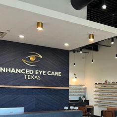 the entrance to an eye care store with tables and chairs in front of large sign