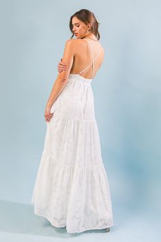 A textured woven maxi dress featuring surplice cami top, tiered skirt, bare back with criss-cross straps and back zipper closure Details Self: 100% Polyester Lining: 100% Polyester Size & Fit - Model is 5`8" And Wearing Size Small - Measurements Taken From Size Small - Approx. Length: 50" White Graduation Dress Long, Graduation Dress Long, White Beach Dresses, Confirmation Dresses, Beach White Dress, Bachelorette Party Dress, Senior Photo Outfits, Hoco Dress, Rehearsal Dinner Dresses