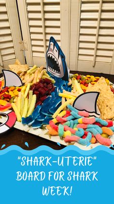 there is a shark theme on the table with snacks and crackers in front of it