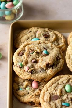 chocolate chip cookies with m & m candies in a baking pan on a table