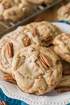 several cookies with pecans are on a plate