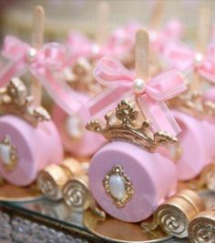 small pink and gold carriages with bows on them