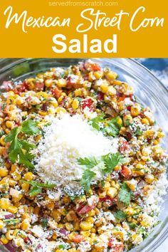 mexican street corn salad in a glass bowl with parmesan cheese and cilantro