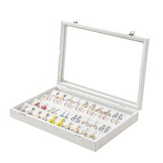 an open jewelry box filled with lots of earrings