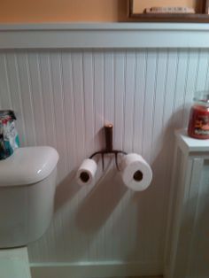 two rolls of toilet paper are hanging on the wall