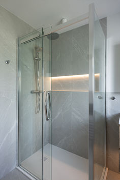 a walk in shower sitting inside of a bathroom