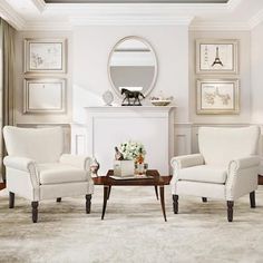 a living room filled with white furniture and framed pictures