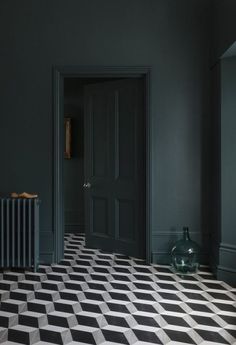 a black and white checkered floor in an empty room with a radiator