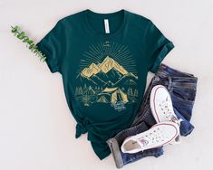 Prepare to embark on a journey of a lifetime with our 'Adventure Awaits' shirt! This shirt is not just a piece of clothing, it's a symbol of endless possibilities and exciting experiences waiting to be discovered. Made with high-quality fabric and featuring a bold and inspiring design, this shirt is perfect for explorers, dreamers, and anyone with a passion for the great outdoors. Whether you're climbing mountains, camping under the stars, or simply seeking new adventures, let this shirt be your companion on the path to new discoveries. Adventure truly awaits, and with this shirt, you'll be ready to embrace it every step of the way. Unisex Jersey Short Sleeve Tee Bella+Canvas 3001 This classic unisex jersey short sleeve tee fits like a well-loved favorite. Soft cotton and quality print mak Green Summer Adventure Top, Summer Adventure Short Sleeve Shirt, Summer Green Top For Camping, Green Summer Top For Camping, Summer Shirt With Screen Print For Outdoor Activities, Summer Camping Tops With Screen Print, Summer Outdoor Shirt With Screen Print, Pre-shrunk Summer Adventure Shirt, Pre-shrunk Summer Shirt For Adventure