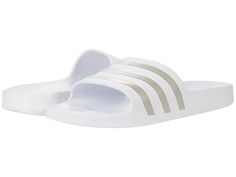 adidas Adilette Aqua Slides - Athletic Shoes : White/Platin Metallic/White : adidas Adilette Aqua Slides feature a classic slip-on style slide with three stripes. Synthetic upper. Synthetic lining and insole. Synthetic outsole. Imported. Measurements: Weight: 4 oz Product measurements were taken using size Men's 8, Women's 9, width Medium. Please note that measurements may vary by size. Weight of footwear is based on a single item, not a pair. Adidas Slip-resistant Slip-on Slides, Comfortable Adidas Slip-on Slides, Adidas Slip-on Slides, Adidas Slides For Swimming With Synthetic Material, Adidas Slides For Swimming With Logo, Adidas Logo Synthetic Slides For Swimming, Adidas Slides With Logo For Swimming, Sporty Adidas Slides Suitable For Water, Sporty Adidas Slides For Swimming