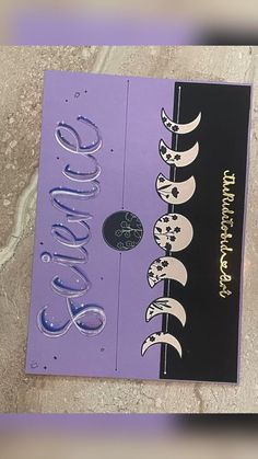 a purple book with black and white writing on it