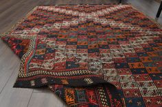 an old rug is laying on the floor