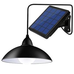 a solar powered wall light with a black shade on the side and an overhead lamp attached to it