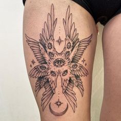 a woman's thigh with an owl and moon tattoo design on the side of her leg