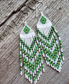 These white, green and dark blue beaded earrings are a beautiful addition to your wardrobe. They measure 4.5" long from the top of the earwire to the bottom of the beads and 1" wide. Green Beaded Dangle Earrings With Large Beads, Green Large Beaded Dangle Earrings, Western Style Wedding, Diy Seed Bead Earrings, Blue Beaded Earrings, Seed Bead Jewelry Patterns, Boho Cowgirl, Handmade Earrings Beaded, Bead Stitching