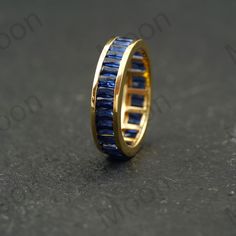 Baguette Blue Sapphire Eternity Band, Full Eternity Sapphire Gemstone Wedding Band, Solid Gold Silver Stacking Ring, September Birthstone  ◈ Item Details ◈ Metal: 925 Sterling Silver  Style: Gemstone Ring Main Stone: Sapphire( Lab Created ) Main Stone Color: Blue Main Stone Shape: Baguette  Birthstone Month: September S I L V E R J E W E L R Y C A R E Silver is not the best friend of oxygen and sulfur; it can be oxidized and tarnished from time to time it is the nature of silver. To keep the silver shiny and prevent it from oxidizing fast, we would recommend the following instructions; * Avoid any chemical agents including perfume, makeup, and hair spray. * Avoid wearing silver jewelry to the beach, shower, or exercise. * Remove before you sleep, clean it with a silver cloth, and keep it i Baguette Cut Sapphire Jewelry For Wedding, Sapphire Baguette Cut Wedding Jewelry, Blue Baguette Cut Wedding Jewelry, Blue Jewelry With Channel Set For Wedding, Channel Set Sapphire Jewelry For Weddings, Wedding Sapphire Rings Channel Set, Gemstone Wedding Band, Blue Sapphire Eternity Band, Sapphire Eternity Band