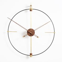 a clock that is on the side of a wall with gold hands and two bars