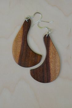 "A handmade pair of African Mopane wood earrings with sterling wires.  These earrings are natural color, finely sanded and then a penetrating oil has been used after which they are 3 stage buffed with final stage being wax.  Earrings are 3.25 inches long including the wires and about 1/8 inch thick and 1.4\"wide" Artisan Wood Handmade Earrings, Natural Wood Jewelry With Natural Variations, Natural Wood Jewelry With Variations, Unique Natural Wood Earrings, Brown Teardrop Wood Jewelry, African Wooden Earrings, Nature-inspired Brown Wooden Jewelry, Brown Wood Drop Earrings, Acorn Decorations