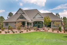 a large house sitting on top of a lush green field