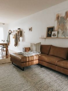 a living room filled with furniture and a rug on top of a carpeted floor