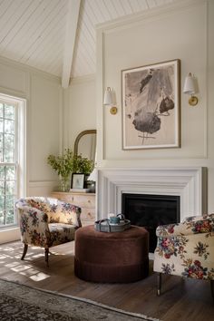 a living room filled with furniture and a fire place in front of a painting on the wall