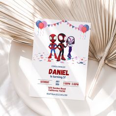 a birthday party card on a plate with balloons and streamers in the shape of two people