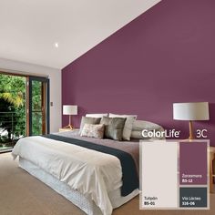 a bedroom painted in shades of purple and grey with a large window overlooking the backyard