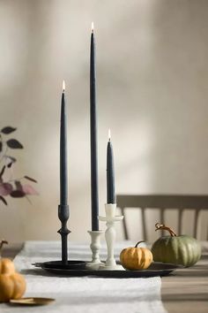 a table with candles and pumpkins on it