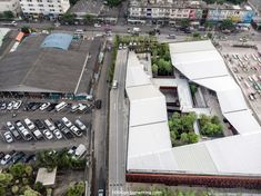 an aerial view of a parking lot with many cars parked in front of the building