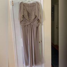 a dress hanging up on a door