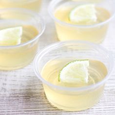 four cups filled with lemonade and lime slices