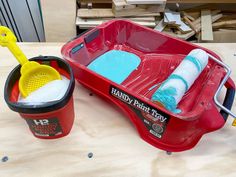 two buckets with cleaning supplies in them sitting on a table