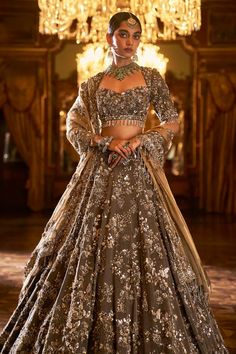 This lehenga set features intricate embroidery in sequin, bead and crystal in antique tones on a coffee brown tissue silk base. The elbow sleeve blouse has tassels at sleeve hem and is paired with a contrasting antique gold tissue dupatta with matching heavy embroidery.From Seema Gujral's Falaknuma collection. DELIVERY TIMEPlease allow 8-12 weeks for your outfit to arrive. FABRIC DETAILSLehenga & Blouse - Tissue Silk Dupatta - Tissue organza Professional cleaning only. Luxurious Lehenga, Tissue Lehenga, Elbow Sleeve Blouse, Tissue Dupatta, Orange Lehenga, Indian Outfits Lehenga, Indian Wedding Outfit, Indian Bride Outfits, Natural Gray Hair