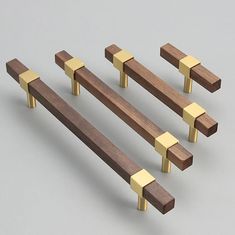 four pieces of wood with gold colored handles